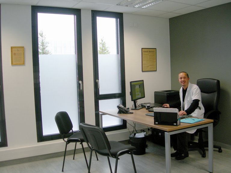 Dr. Thomas Raphael in his office working on the computer 