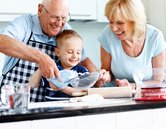 Senior couple and small kid preparing food Senior couple and small kid preparing food in the kitchen